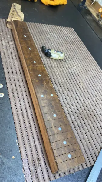 Braço de guitarra com marcadores de escala na bancada